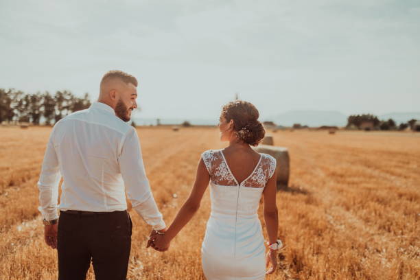 istock a young married couple in a large field enjoys the sunset. Selective focus 1335307651
