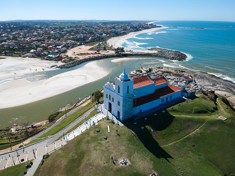 Aerial view of Saquarema and Itaúna beach in Rio de Janeiro. Famous for the waves and the church on top of the hill. Sunny day. drone photo.
