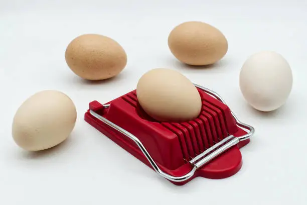 Household device for slicing eggs. Hard-boiled eggs slicer tool.