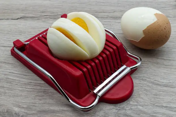 Household device for slicing eggs. Hard-boiled eggs slicer tool.