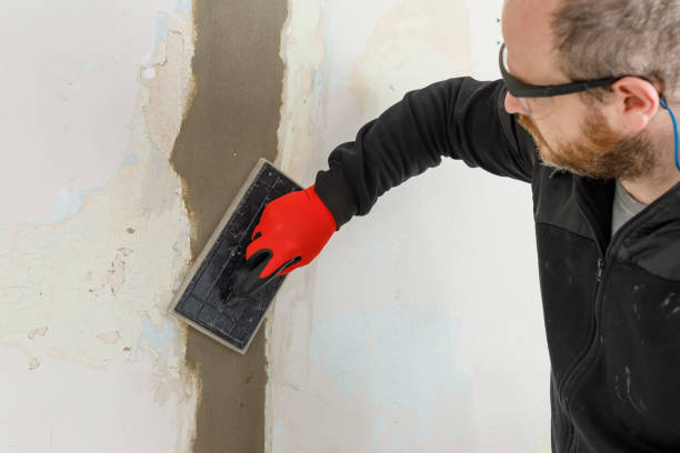 istock mason smoothing or repairing the wall with a trowel. Masonry work. Construction industry. 1335315060