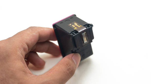 istock Hand holding a Tri-color Ink Cartridge for printer. 1335318912
