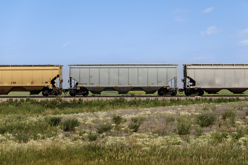 Railcars along the tracks seen from the highway in the Alberta Canada prairies