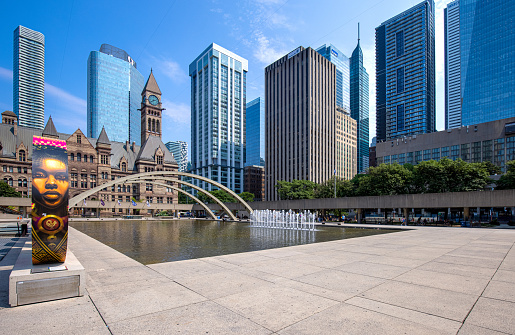 Toronto, Canada, August 10, 2021: Famous Toronto City Hall and Nathan Phillips Square fountain, a major tourist attraction and social hub for public events and festivals