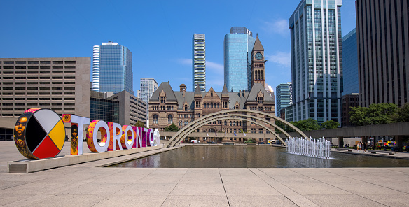 Toronto, Canada, August 10, 2021: Famous Toronto City Hall and Nathan Phillips Square fountain, a major tourist attraction and social hub for public events and festivals