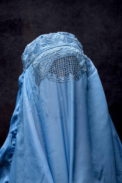 istock Little girl wearing a burka looking up 1335321084
