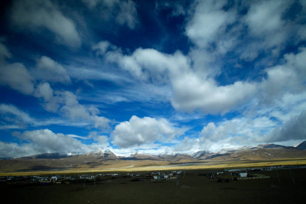 istock The blue sky white clouds and grassland snow mountain landscape 1335329713