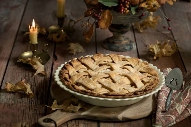 Apple Pie Autumn inspired apple pie with pumpkins, gourds and holiday decor arranged against an old wood background apple pie a la mode stock pictures, royalty-free photos & images