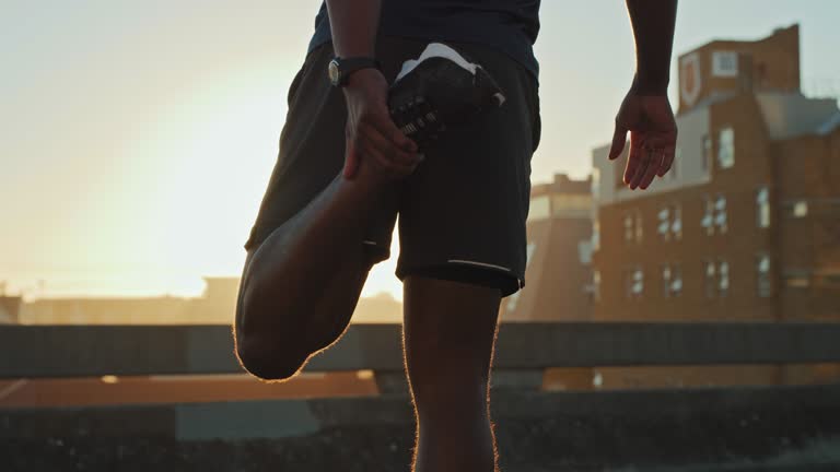 4k video footage of an unrecognisable man working out in the city at sunset