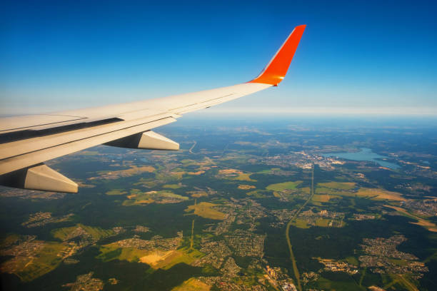 istock Classic image through aircraft window onto wing. Flight view over Russia 1335340663
