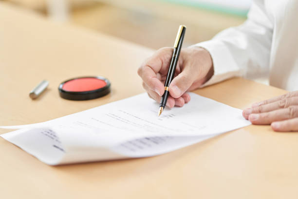 istock Elderly people signing contracts 1335341598