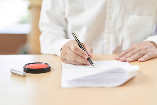 istock Elderly people signing contracts 1335341606