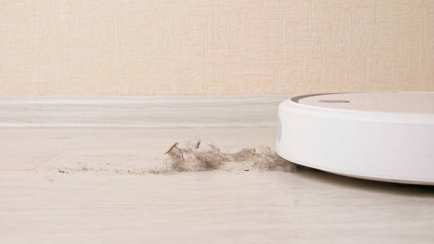 istock Robotic vacuum cleaner hoovers wooden floor from dirt 1335342427