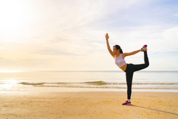 istock Women yoga on the beach 1335343022
