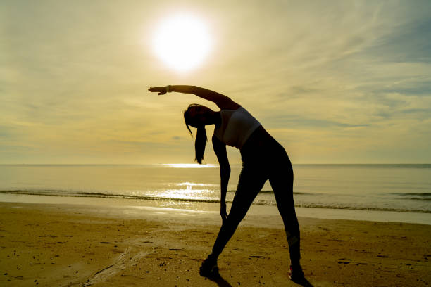 istock Silhouette women exercise on the beach 1335343023