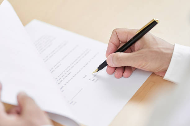 istock Elderly people signing contracts 1335345489