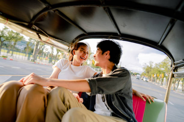 good-humored couples enjoy memorable moments together in a tuk-tuk. - jinrikisha thailand tuk transportation imagens e fotografias de stock