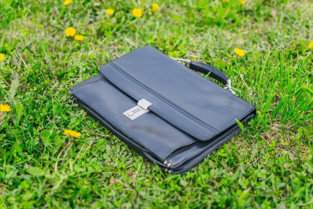 istock Forgotten briefcase with documents lies on the lawn 1335354553