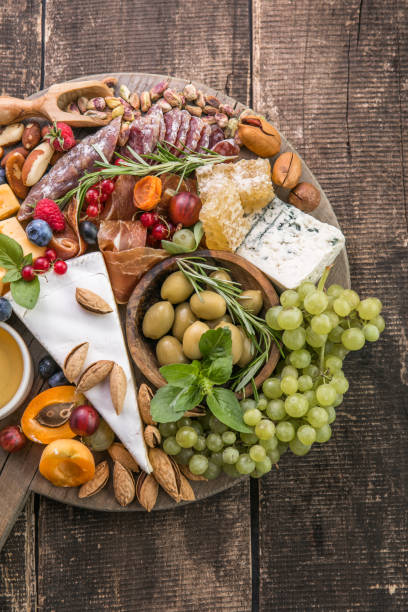 istock Antipasto background. Different Italian snacks with fruit, nut on a rustic background. 1335361291