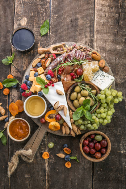 istock Antipasto background. Different Italian snacks with fruit, nut on a rustic background. 1335361293