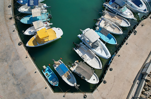 Aerial drone view of fishing boats moored at the harbor. Agia triada Paralimni Cyprus