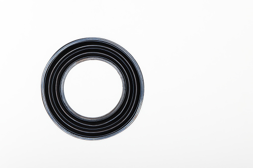 Black rubber ring - gasket, parts for car repair. A set of spare parts for servicing the braking system of a vehicle. Details on white background, copy space available.