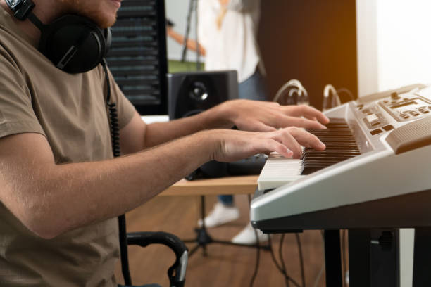 istock Musician man hand play piano in studio recording. 1335365624