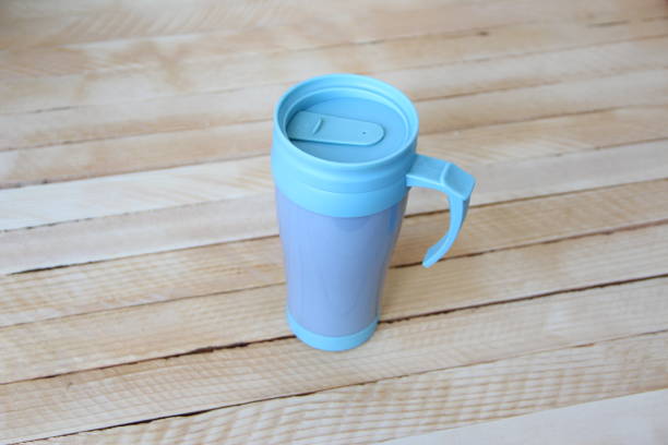 istock Blue thermo mug on wooden background 1335367744