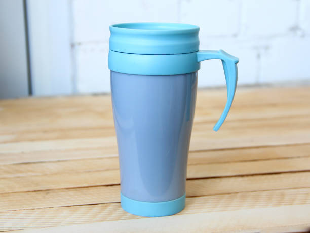 istock Blue thermo mug on wooden background 1335367747