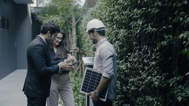 istock Businessman and engineers at a solar panel energy plan 1335367907