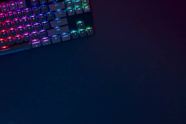 istock Rainbow colors backlighted gaming computer keyboard in corner of workspace. 1335368698