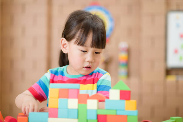 istock Young Girl Playing Creative Toy Blocks For Home Schooling 1335371049