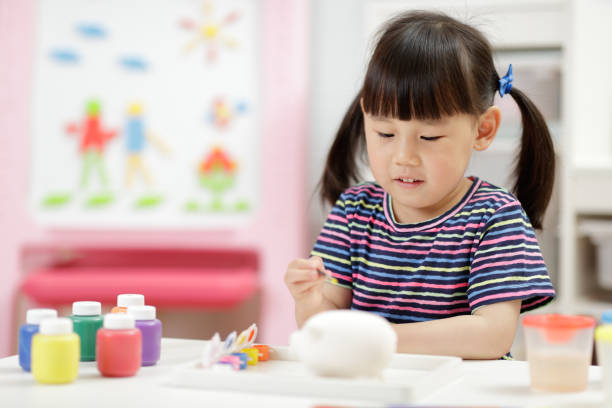 istock Young Girl Decorating Handmade Craft For Home Schooling 1335371058