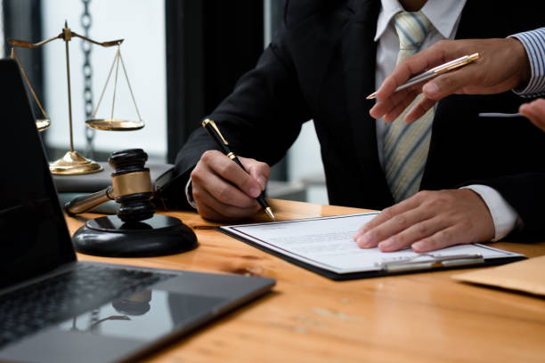 istock Consulting and finding a solution Concept, businesspeople consult with a lawyer or judge to find out about business fraud. 1335371663