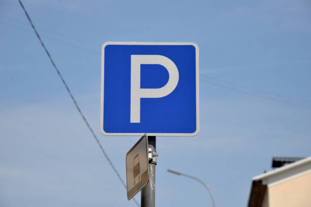 istock Parking sign at house on blue sky background 1335373121
