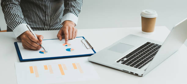 istock bookkeeper or financial inspector hands making report, calculating or checking balance. Home finances, investment, economy, saving money or insurance concept 1335374612