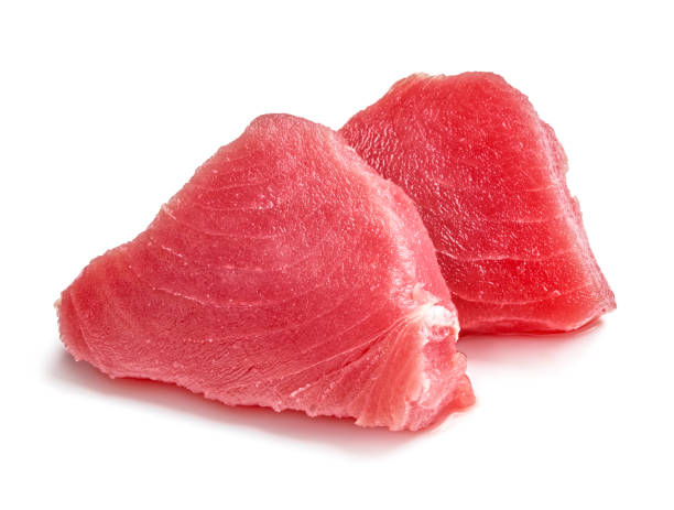 due fette di carne di tonno crudo isolate su sfondo bianco - tuna steak fillet food plate foto e immagini stock