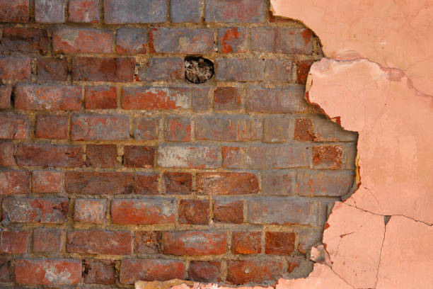 istock peeled off pink plaster on old red brick wall flat full frame background and texture 1335380112