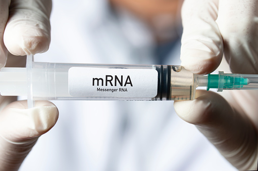 Doctor holding mRNA vaccine. mRNA: Messenger RNA. mRNA is a type of vaccine.
