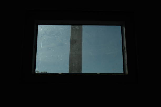 istock looking through small window in the blue sky 1335387142