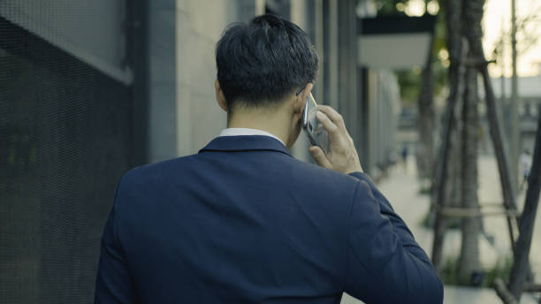 istock Businessman talking on mobile phone checking the time 1335388220