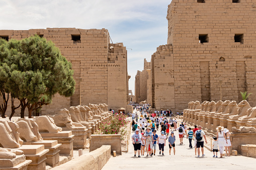 Sphinxes road at the Karnak Temple Complex in Luxor, Egypt. Tourists from all over the world are visiting the temple in Luxor.