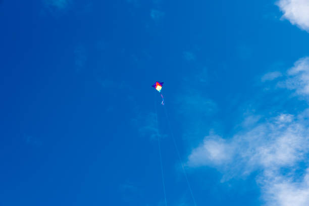istock Colorful Kites flying over the sky 1335390388