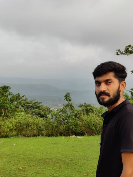 istock Young Handsome Indian man standing in a meadow 1335391326