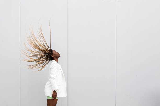 young african american woman tossing long blond braided hair back. copy space. - braided braids women long hair imagens e fotografias de stock