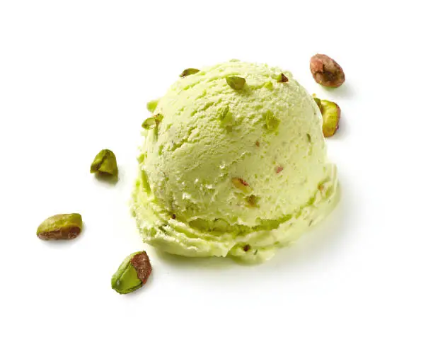 Scoop of pistachio ice cream with pistachio nuts on white background. Ice cream isolated for package design of pistachio ice cream.