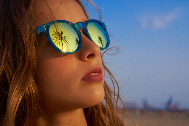 istock Brunette girl sunglasses with palm tree 1335396940