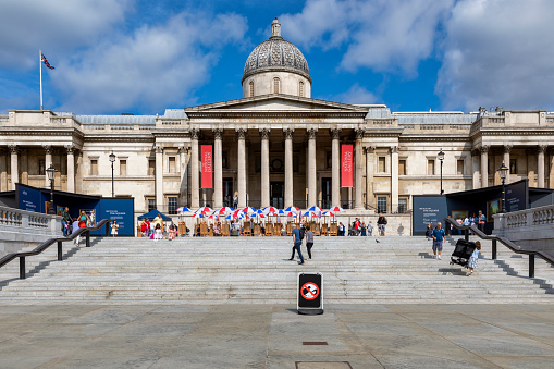 London, UK – Aug 19, 2021: Tourists and visitors on a sunny day, outside the entrance of the National Gallery in Trafalgar Square