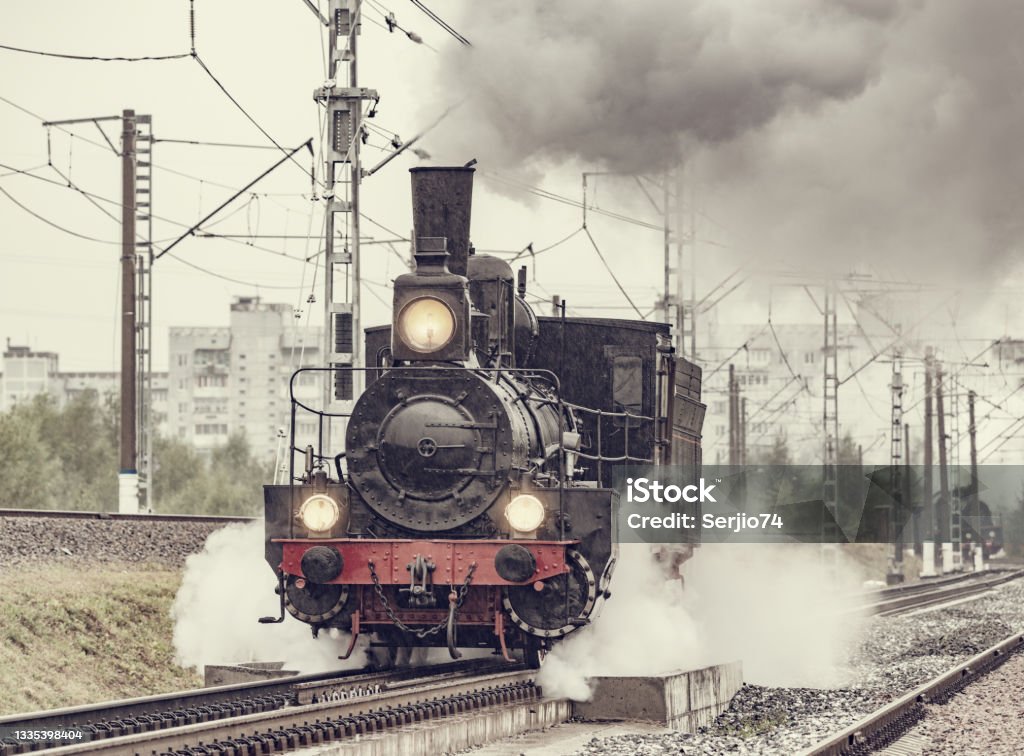 Retro steam locomotive moves under the rain. Retro steam locomotive moves under the pouring rain. Freight Train Stock Photo