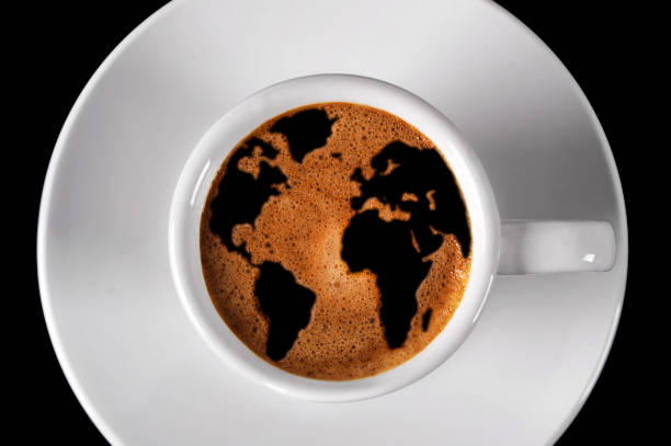 istock Cup of coffee with world map in cream 1335399704